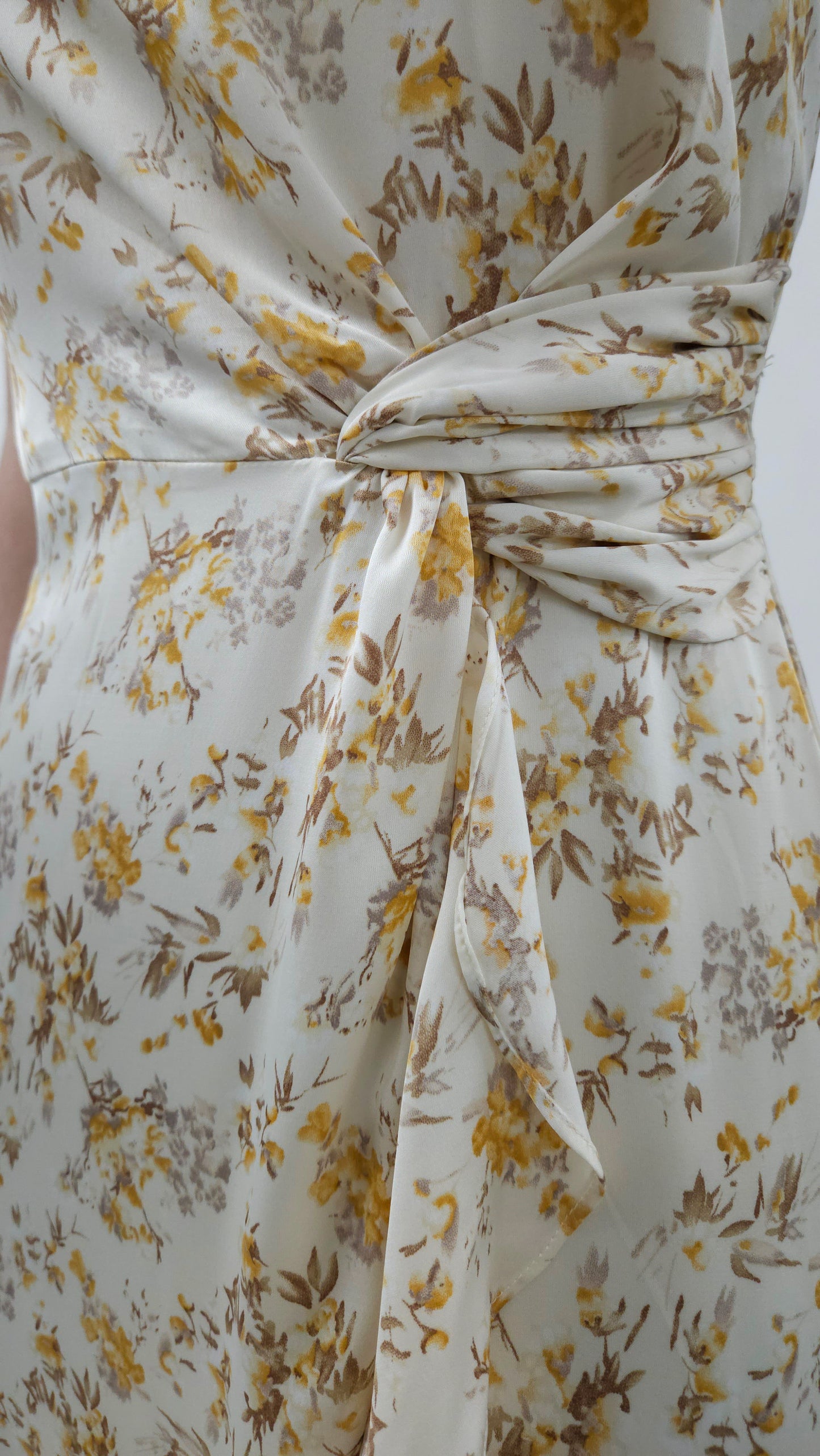 Beautiful ivory square neck midi dress with twist tie and elegant ruffle detail. Smocked back detail with zipper closure.