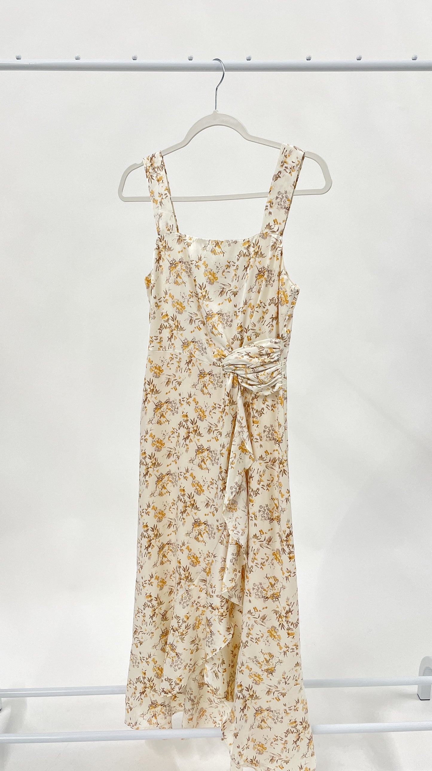 Beautiful ivory square neck midi dress with twist tie and elegant ruffle detail. Smocked back detail with zipper closure.