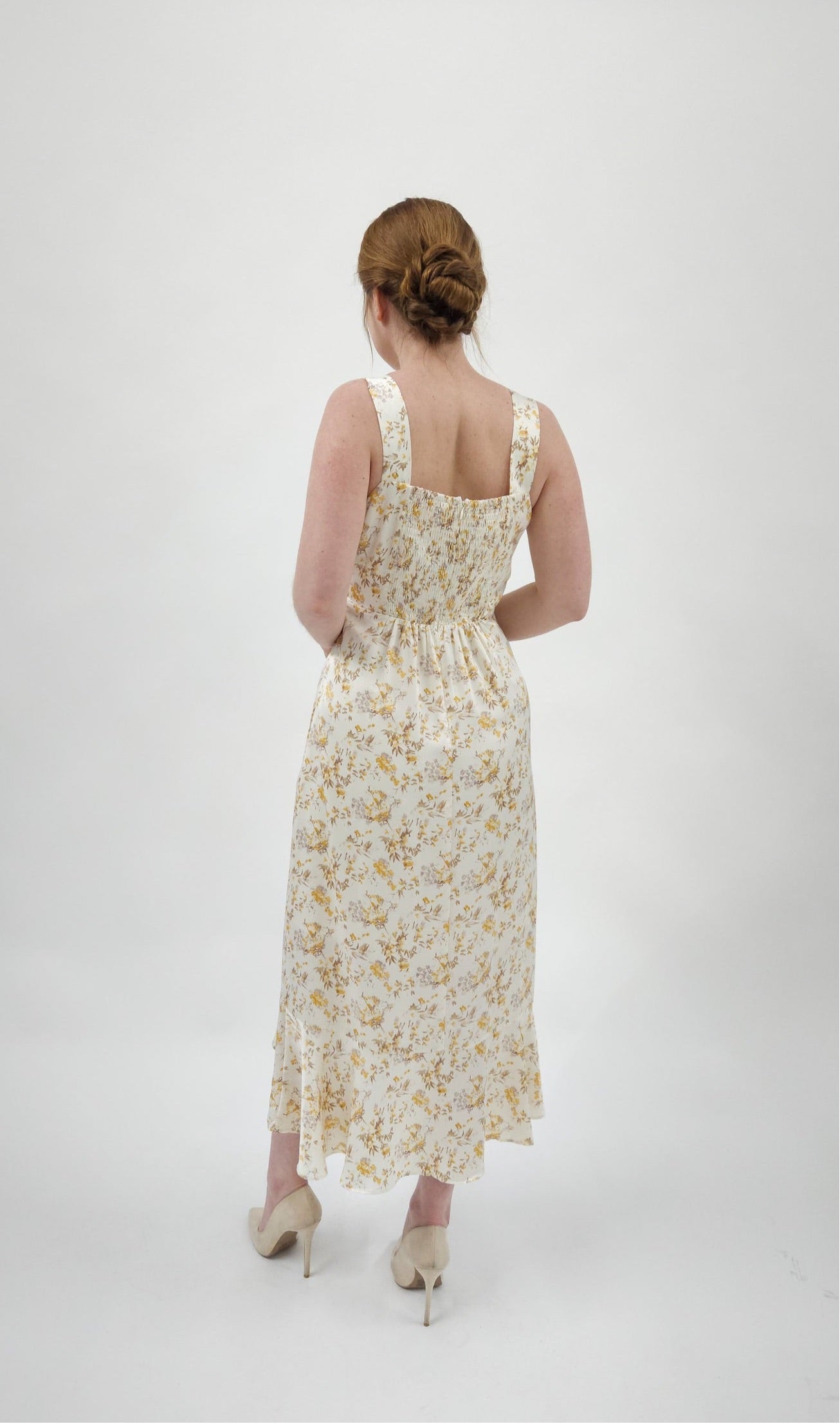 Beautiful ivory square neck midi dress with twist tie and elegant ruffle detail. Smocked back detail with zipper closure. 