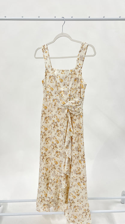 Beautiful ivory square neck midi dress with twist tie and elegant ruffle detail. Smocked back detail with zipper closure. 
